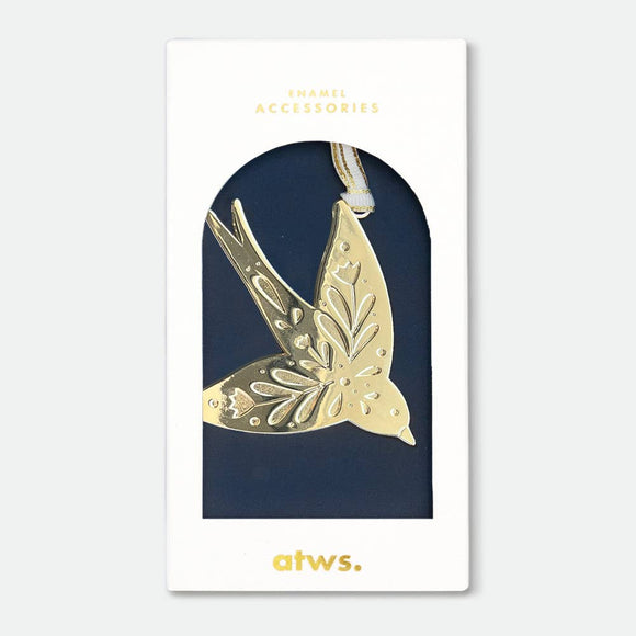 A gold-plated enamel Christmas ornament in the shape of a swallow, packaged on a navy-colored card with 'ATWS' branding.
