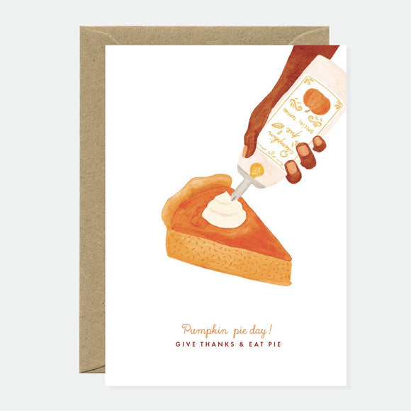 Greeting card with an illustration of a slice of pumpkin pie and a hand pouring whipped cream, with the text 'Give Thanks & Eat Pie!'.