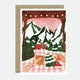 Illustration of two hands holding mugs on a checkered blanket, with snowy mountains, pine trees, and a wooden canopy in the background.