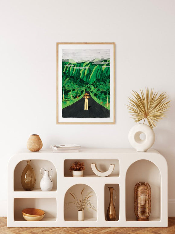 Framed Hawaï poster hanging above a white arched sideboard styled with ceramic vases, dried plants, and bohemian decor.