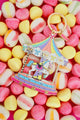 All The Ways To Say carousel keychain with gold details and pastel candy colors – playful flatlay