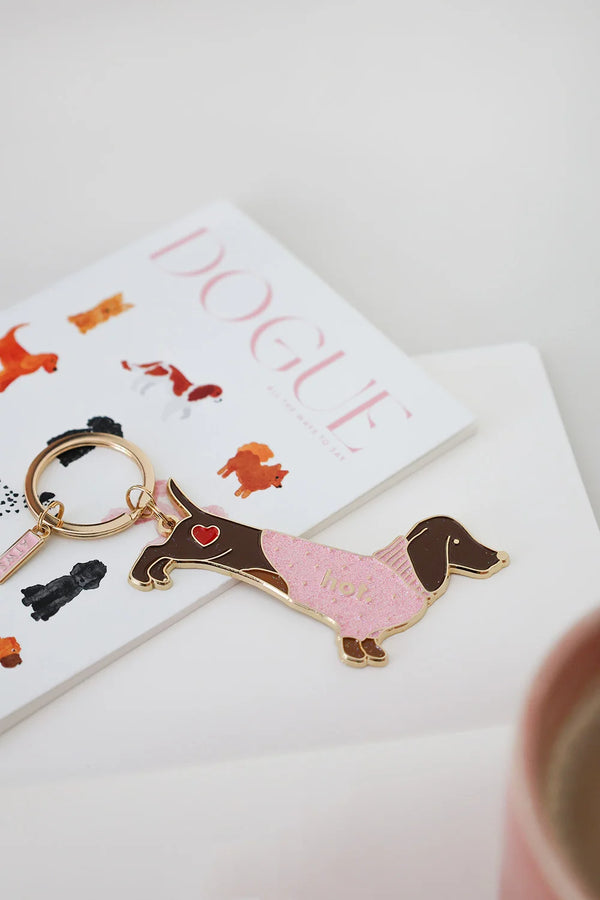 Playful Hot Dachshund enamel keychain by All The Ways To Say photographed with DOGUE card