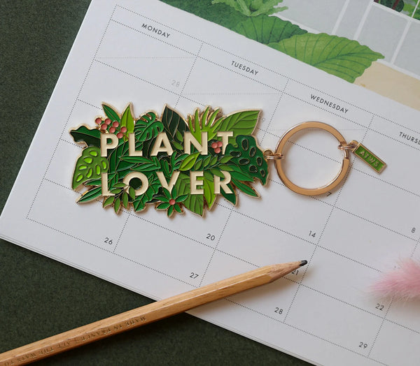 All The Ways To Say Plant Lover enamel keychain – lush green jungle leaves with gold details