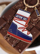 Close-up of After Ski enamel keychain – red, white and blue snow boot with glitter details