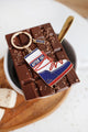 After Ski keychain by All The Ways To Say – enamel boot charm on melted chocolate background