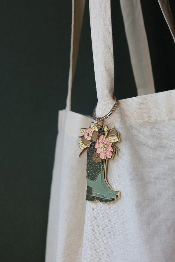 All The Ways To Say enamel keychain – green boot filled with pastel flowers and gold details