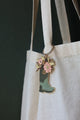All The Ways To Say enamel keychain – green boot filled with pastel flowers and gold details