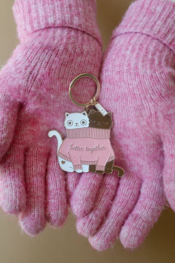 2 Cats in a Sweater keychain held in pink wool gloves – cozy winter accessory by All The Ways To Say