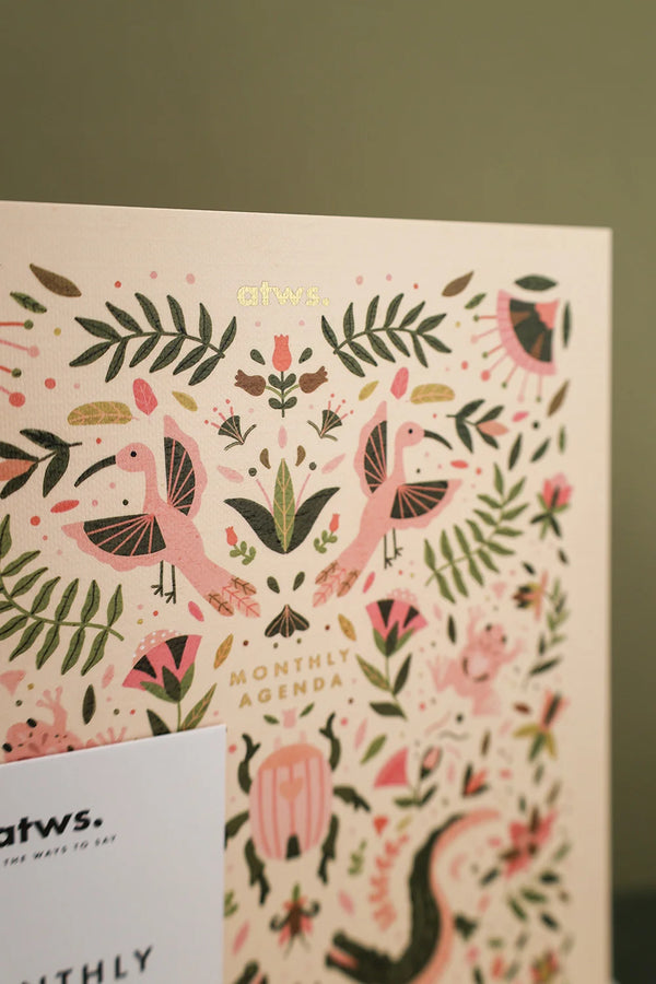 Close up of Pink Croco monthly planner cover with gold foil details and pink bird illustrations