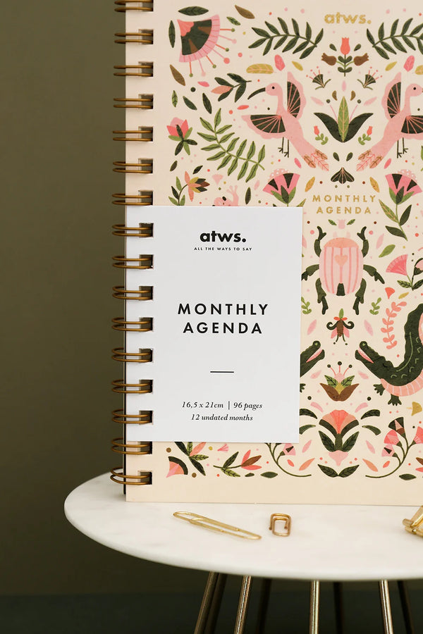 Front cover of Pink Croco monthly planner with white label and gold spiral binding
