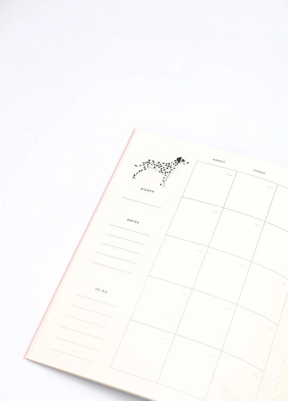 Inside page of Dogue monthly planner featuring a Dalmatian illustration with calendar layout