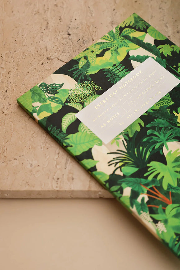 Tropical Green Cliff collection by All the Ways to Say showing notebook, greeting cards and jewellery box with botanical pattern on a warm brown backdrop.