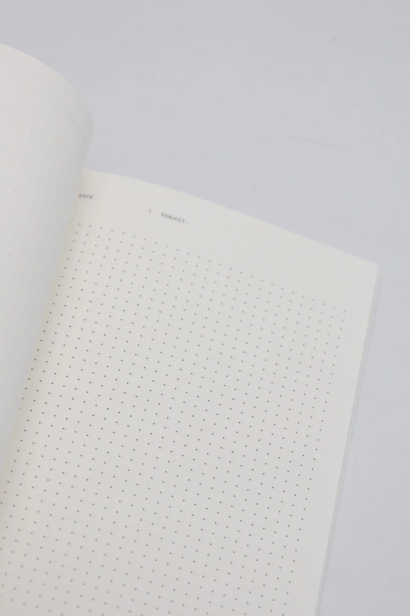 Open dotted notebook page with minimal design, showing clean white paper for writing and journaling.