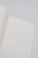 Open dotted notebook page with minimal design, showing clean white paper for writing and journaling.