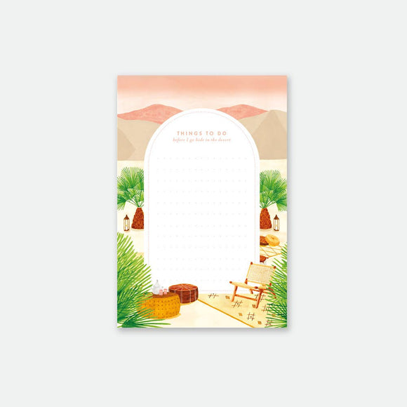 A notepad with an outdoor-inspired design, featuring elements such as a tent, trees, and a chair, indicative of a glamping theme.