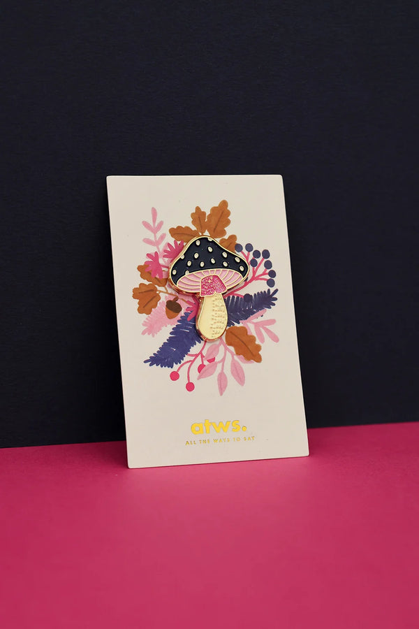 Crazy Mushroom enamel pin by All The Ways To Say on illustrated card with fall foliage – dark blue and pink background