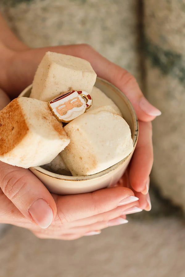 Santa’s Cup enamel pin by All The Ways To Say on marshmallows with golden spoon – cozy holiday aesthetic