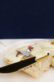 Little Frenchie enamel pin by All The Ways To Say – French dachshund design on buttered bread with dark blue backdrop