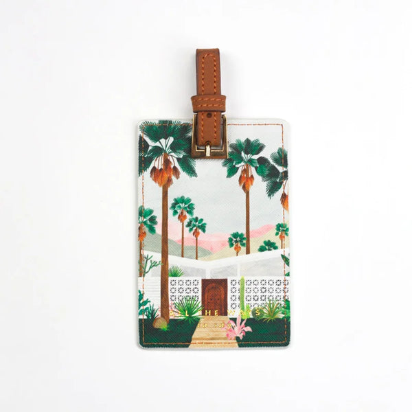 Luggage tag with Palm Springs-inspired illustration featuring tall palm trees and a mid-century house.