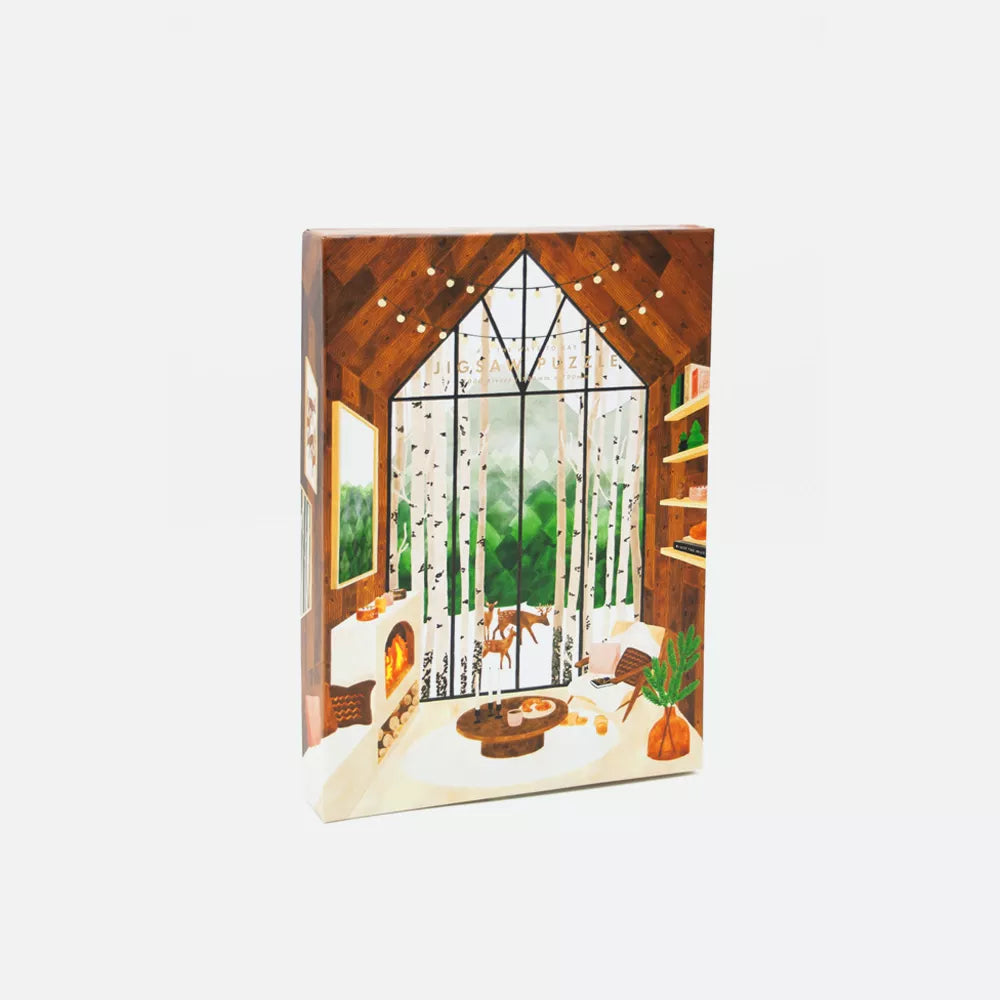 Lapland jigsaw puzzle by All the Ways to Say – cozy wooden cabin with fireplace and birch forest view covered in snow.