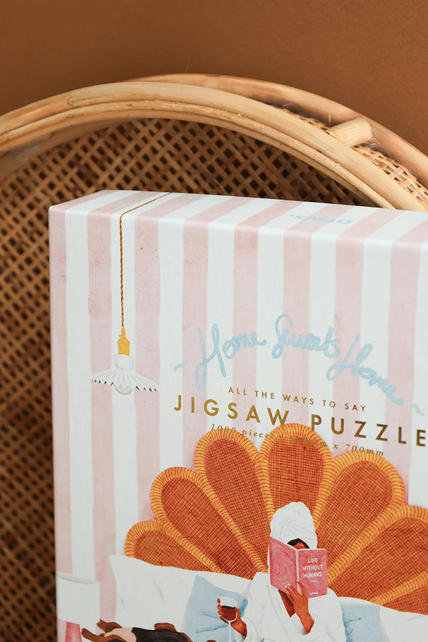 Close-up of Home Sweet Home puzzle box with pink stripes and gold lettering – cozy detail shot