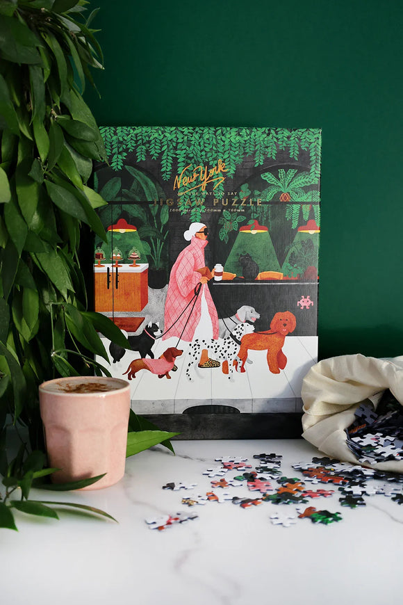 Close-up of The Dog Sitter puzzle pieces showing vibrant colors and detailed artwork of dogs and plants.
