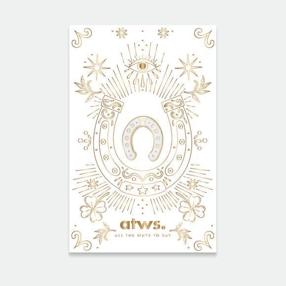 A pack of two gold-plated enamel pins with a horseshoe design and decorative elements, predominantly in gold color, against a white background.