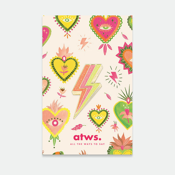 A pack of two colorful enamel pins with gold plating, featuring designs such as hearts and lightning bolts.