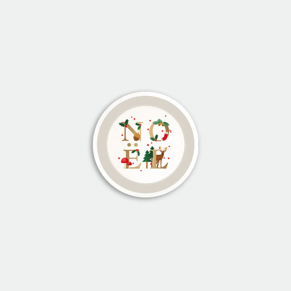 Round coaster with the word “Noël” illustrated using festive elements like holly, fir trees, mushrooms and a reindeer, Noël by All the Ways to Say