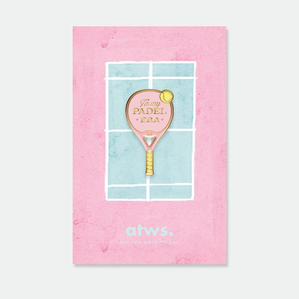 A pink padel racket enamel pin by All The Ways To Say with "In my Padel Era" gold text, displayed on a watercolor court-themed card.