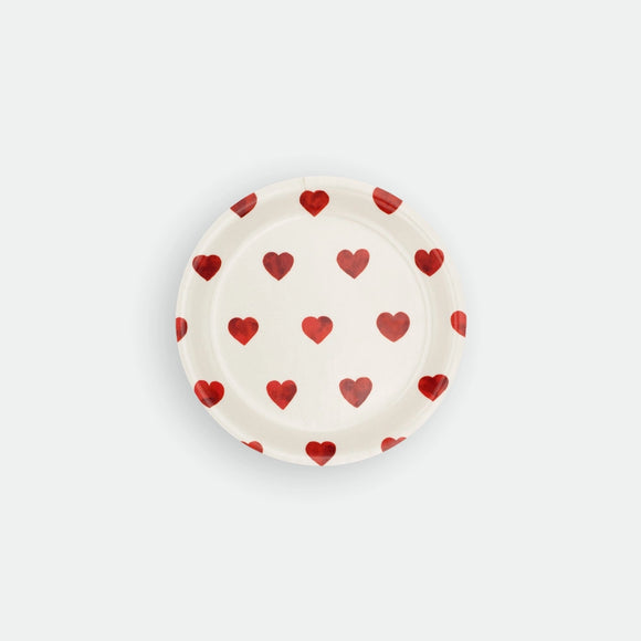 Round birch wood coaster by All the Ways to Say featuring a repeating pattern of small, delicate red watercolor hearts scattered on an off-white surface.
