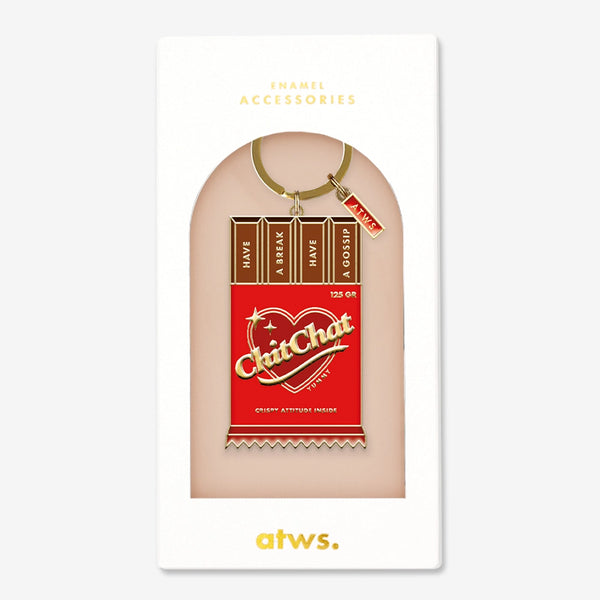 A witty gold enamel keychain by All The Ways To Say shaped like a red chocolate bar with the text "ChitChat" and "HAVE A BREAK HAVE A GOSSIP".