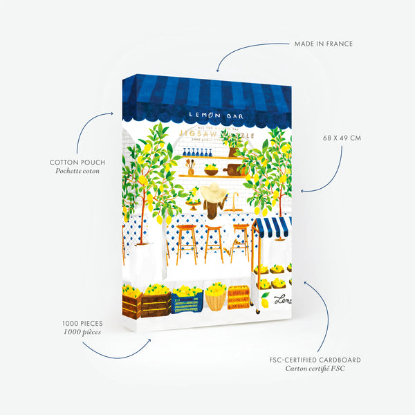 Product features of the Amalfi Lemon Bar 1000-piece jigsaw puzzle by All the Ways to Say. The image highlights technical details: Made in France, FSC-certified cardboard, 68x49 cm size, and an included cotton pouch. The illustration features a lush Mediterranean lemon bar with vibrant yellow lemon trees and blue striped awnings.