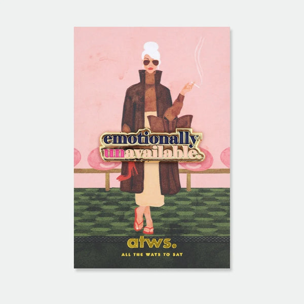 Enamel pin reading "emotionally unavailable" in bold gold and pink lettering
