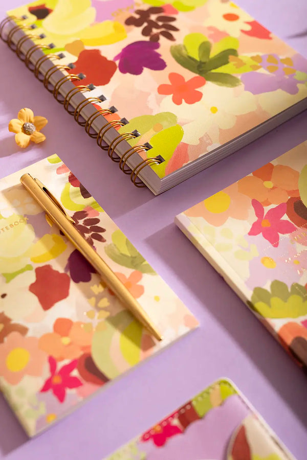 SPRING SWEETS - Collection: macro shot of colorful flower illustrations on notebook covers with gold accents.