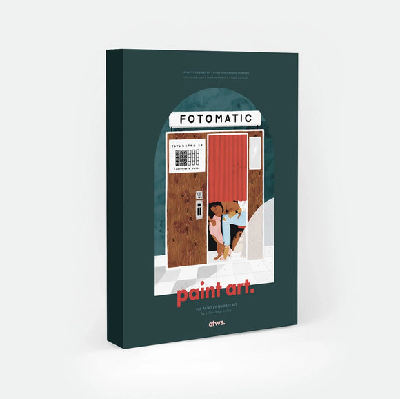 Fotomatic paint by numbers kit box by All The Ways To Say, illustration of a woman and her two dogs squeezed behind the red curtain of a vintage photo booth, "FOTOMATIC" sign above a wooden door and checkered floor, "paint art. The Paint By Number Kit by All The Ways To Say"