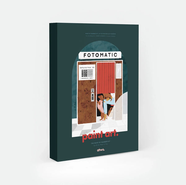 Fotomatic paint by numbers kit box by All The Ways To Say, illustration of a woman and her two dogs squeezed behind the red curtain of a vintage photo booth, "FOTOMATIC" sign above a wooden door and checkered floor, "paint art. The Paint By Number Kit by All The Ways To Say"