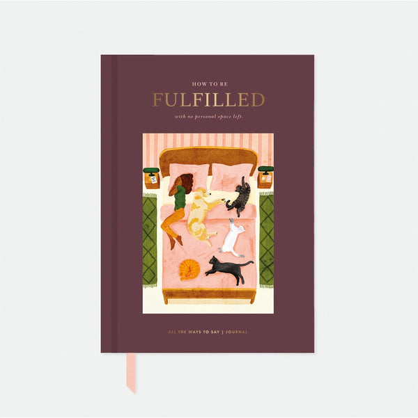 A5 Hardcover notebook with a hand-painted illustration of a woman in bed with four cats and a dog on a burgundy background by All the Ways to Say.