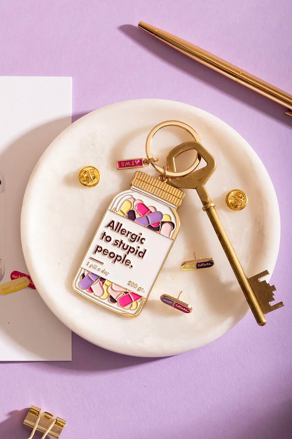Allergic to stupid people Keychain - Displayed on a marble tray with matching pins and a vintage key.