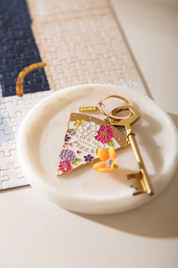 As much as pizza Keychain - Lifestyle view on a marble tray next to a puzzle.