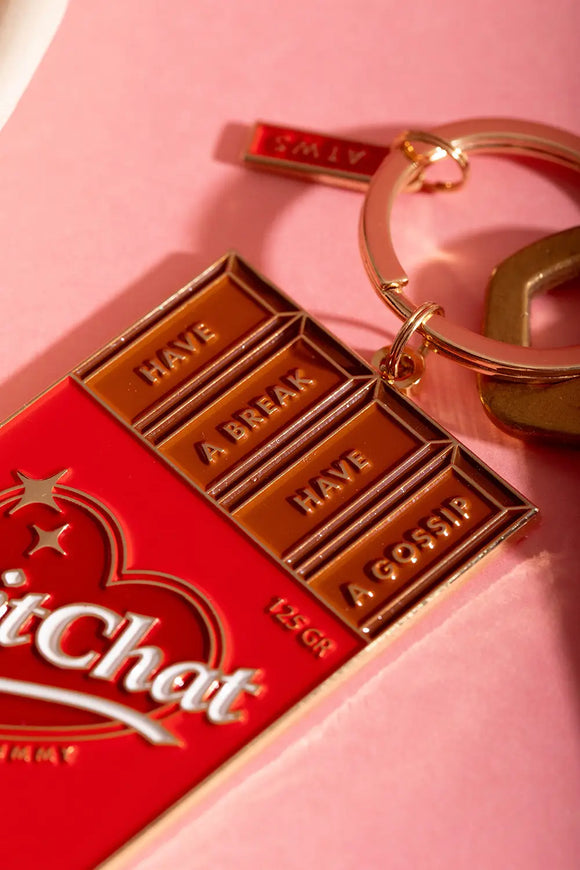 Chit chat Keychain - Macro shot showing the premium golden metal finish and red enamel.