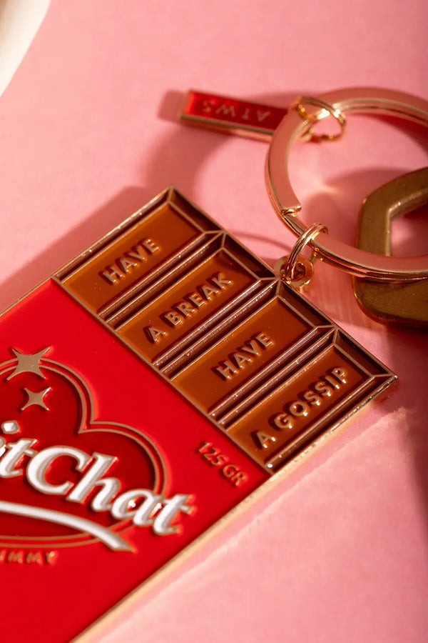 Chit chat Keychain - Macro shot showing the premium golden metal finish and red enamel.