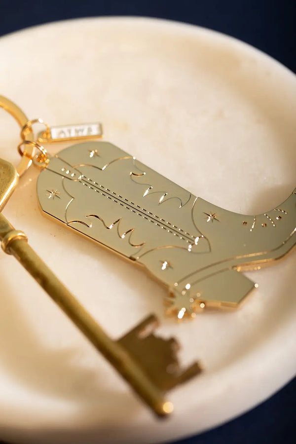 Cowboy Boot Keychain - Close-up on the star engravings and intricate western boot patterns.
