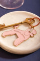 Poodle mood Keychain - Top view of the pink poodle design with a vintage key on white marble.
