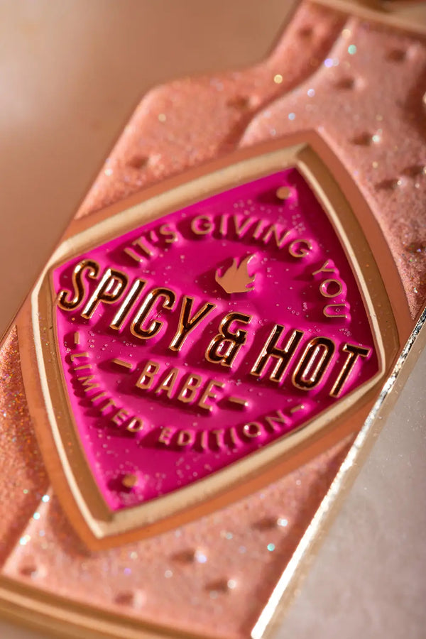 Spicy & Hot Keychain - Detailed focus on the glittery pink enamel and golden text engraving.