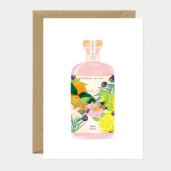 Illustrated birthday greeting card of a pink gin bottle labeled "Birthday Edition," decorated with oranges, lemons, blueberries, and flowers, with gold foil text reading "Let the fun be GIN" and "Infused with love"