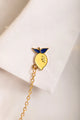 Duo Margarita Chain - Pins: the lemon element of the chain pin attached to a white shirt collar.