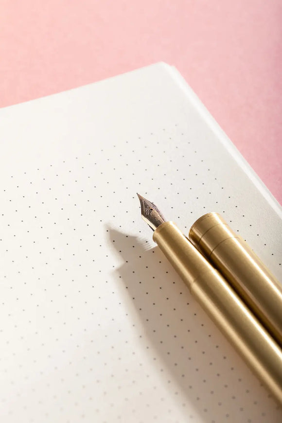 Notebook A5 Life With Pets & Plants - Close-up of the premium dotted paper and a golden fountain pen.