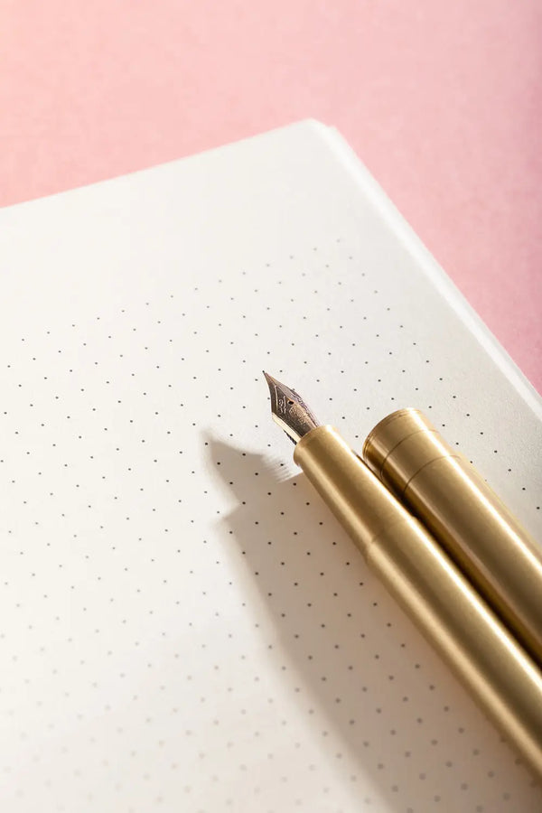Notebook A5 Life With Pets & Plants - Close-up of the premium dotted paper and a golden fountain pen.