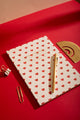 Notebook A5 New Hearts - Lifestyle view on a red background with a golden pen and stationery accessories.